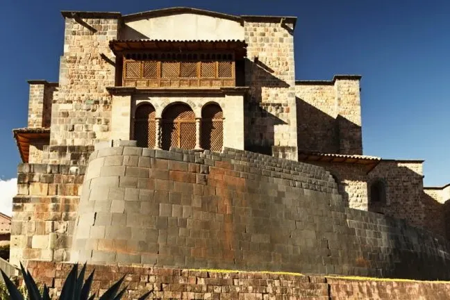 Close-up of the perfectly fitted curved Inca stone wall at the Qorikancha temple in Cusco.