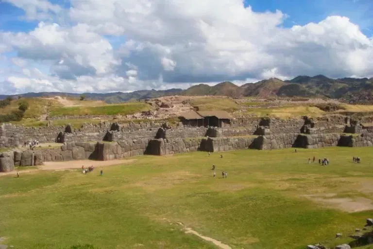 Wide view of the main esplanade and the three levels of zigzagging walls at the Sacsayhuaman archaeological park.