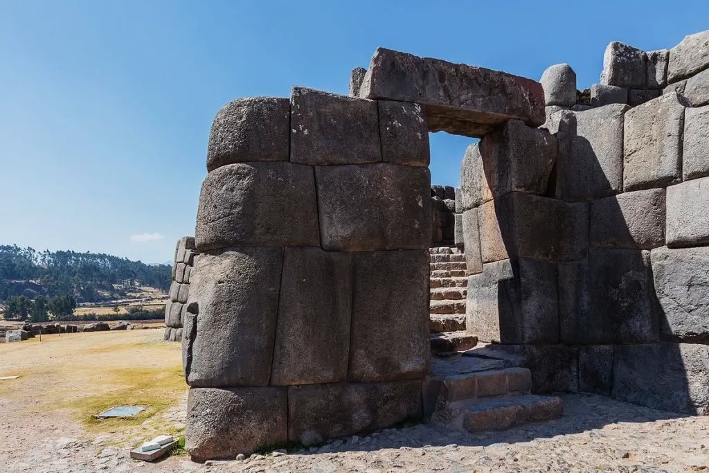 Detailed view of an ancient Incan stone doorway and staircase at the Sacsayhuaman fortress.