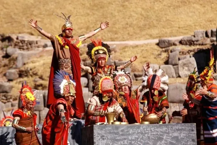The Sapa Inca with arms raised performing a sun blessing ceremony surrounded by high-ranking priests.