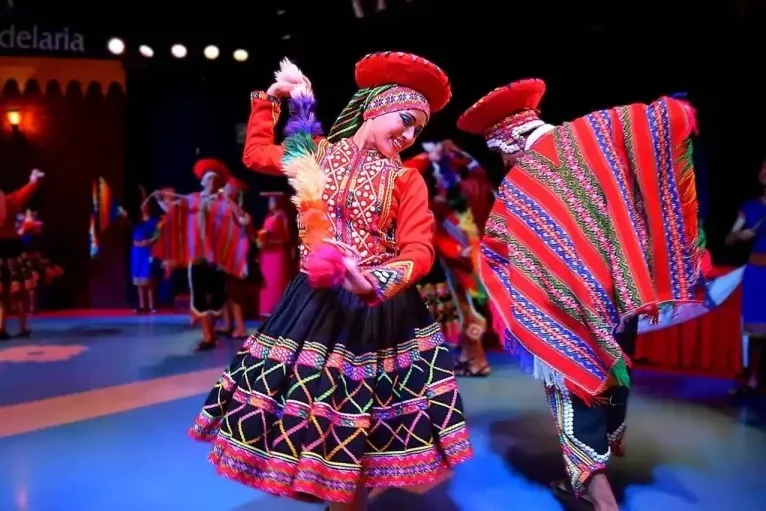 Dancers in vibrant traditional Cusco costumes performing the Valicha, a typical Andean folk dance.
