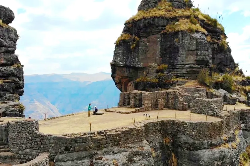 Stone walls and terraces of the Waqrapukara fortress overlooking a deep Andean canyon in Cusco.
