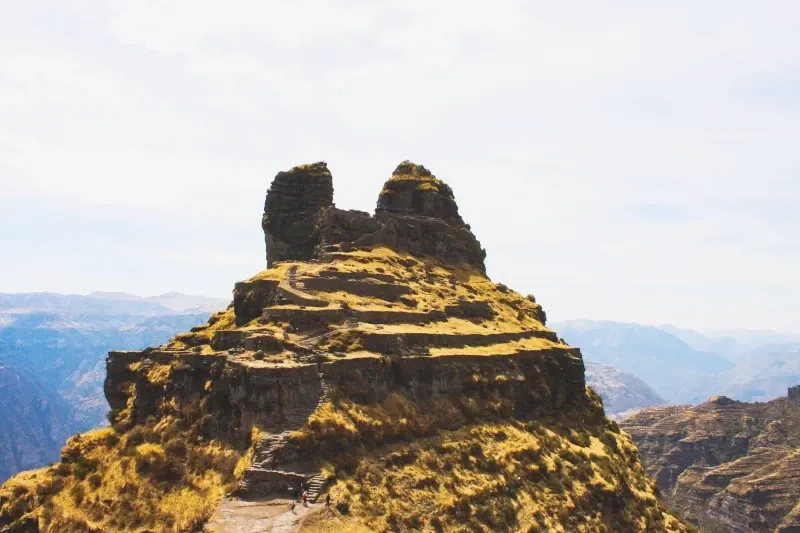 Panoramic view of the horn-shaped Waqrapukara fortress on top of a mountain in the Apurimac River canyon.
